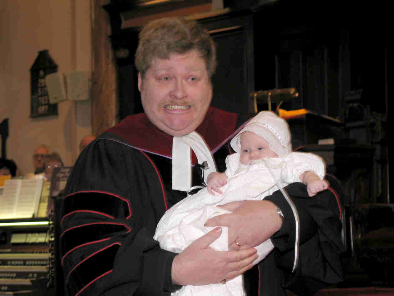 The Reverend Dr. Andrew has established a record of never have a child cry during baptism. He was a little apprehensive, but Olivia didn't break his record!